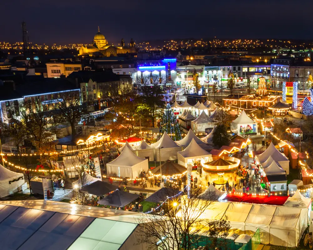 Festive outdoor market with illuminated marquees at night