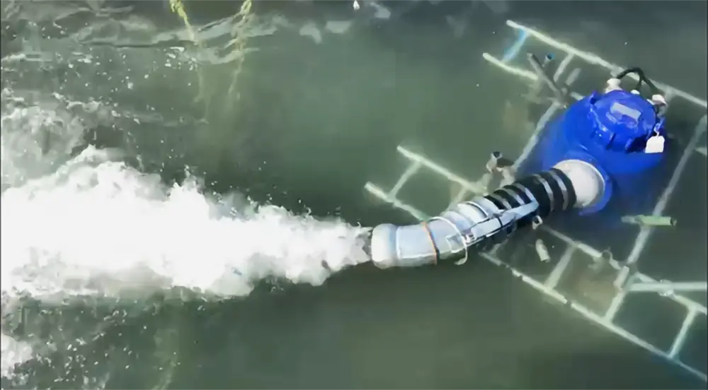 Submersible pump discharging water to create smooth, controlled circulation for a film set moat.