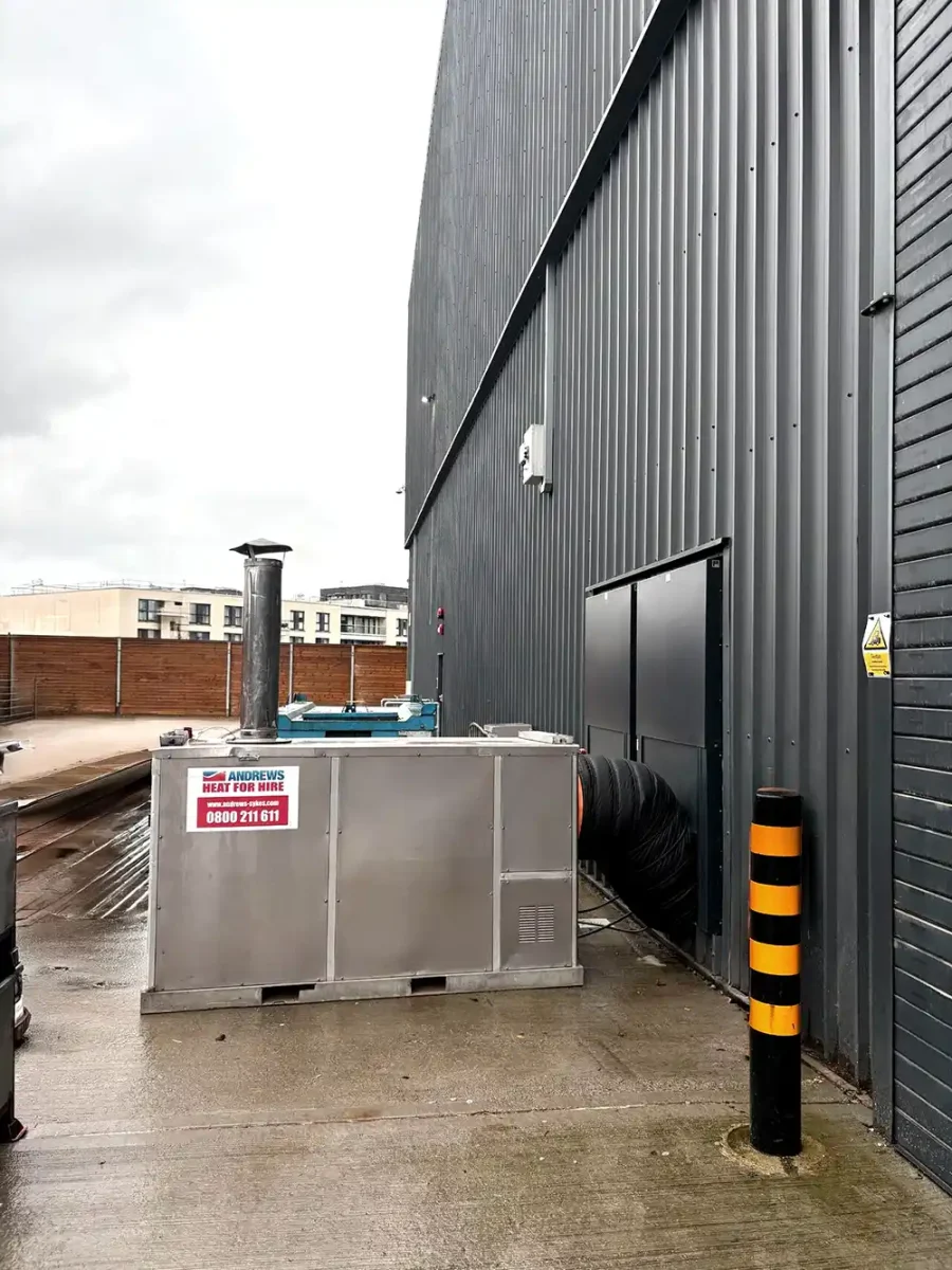 An Andrews Heat for Hire Aurora FH 2000S installed externally, with black ducting routing warm air into a Surrey film studio.