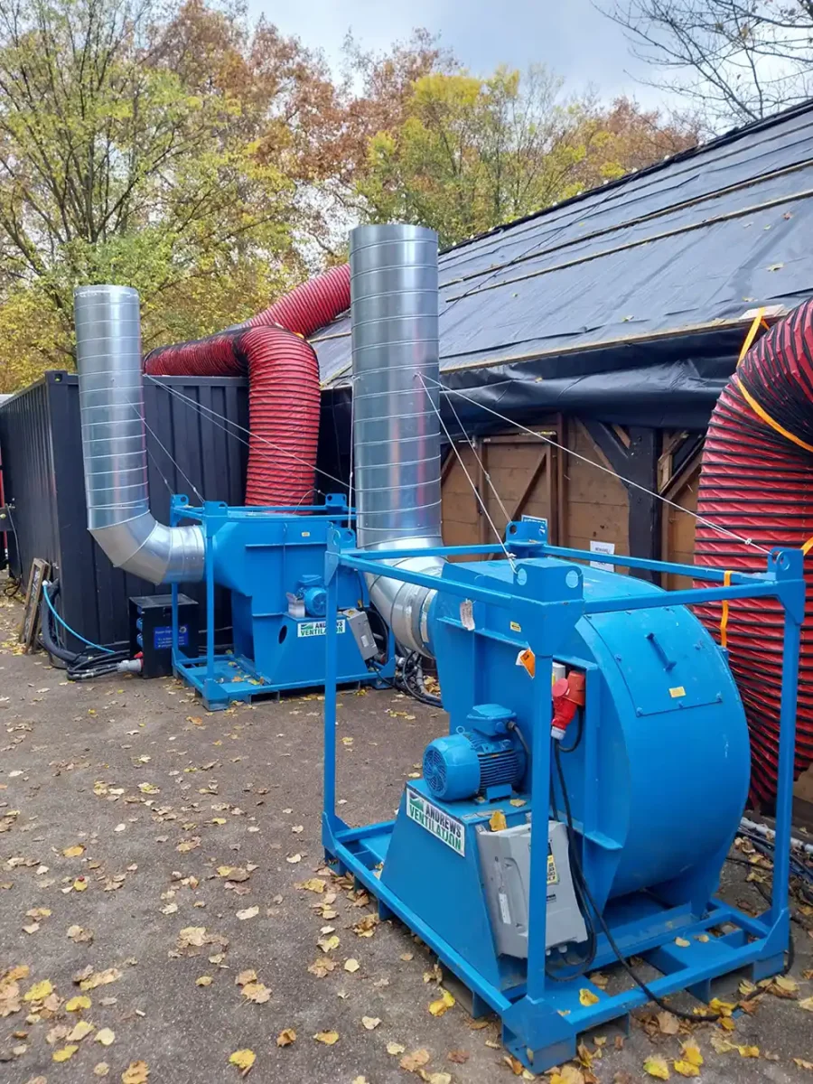 Two heavy-duty Andrews Ventilation extraction fans connected to flexible ducting for continuous smoke removal.