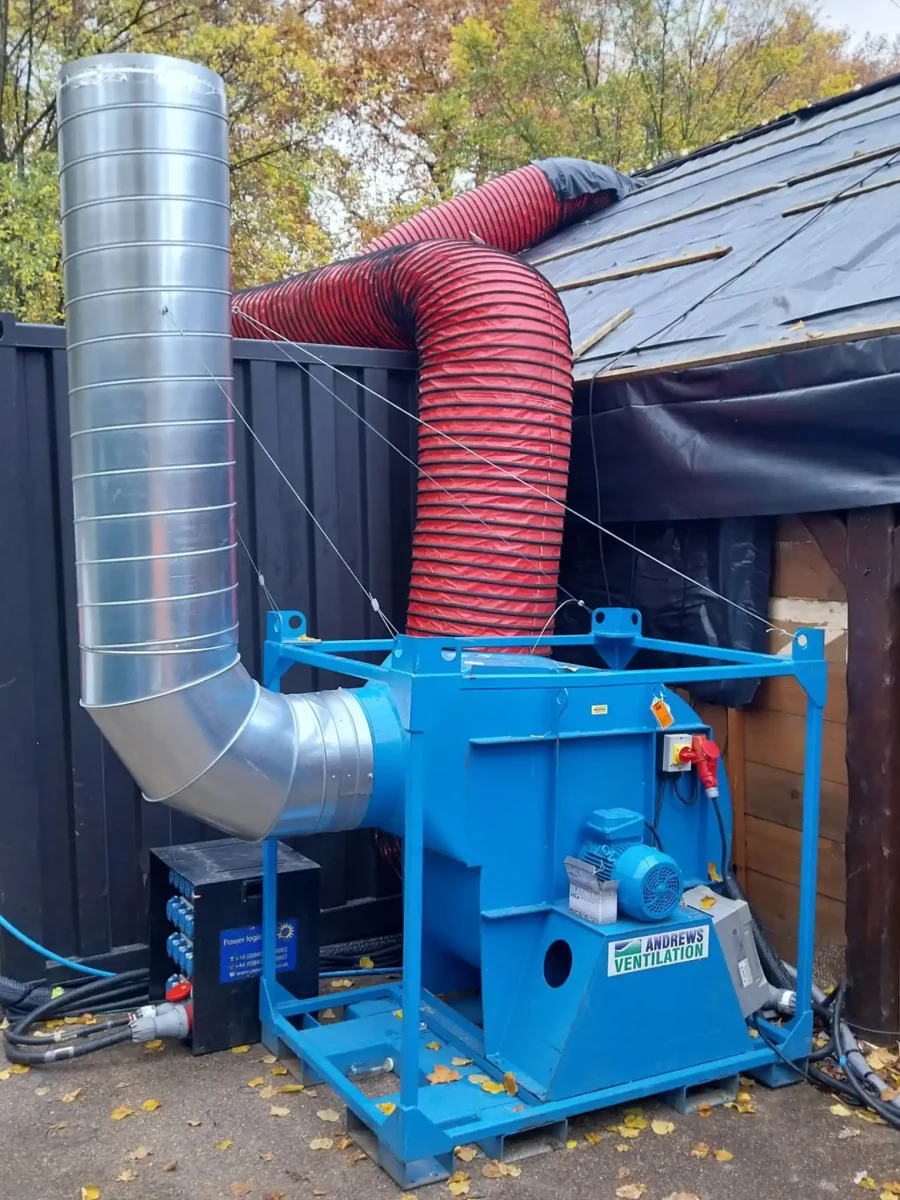 Close-up of an FV900 S2 ventilation unit showing the connection of reinforced flexible ducting to capture smoke from event structures.