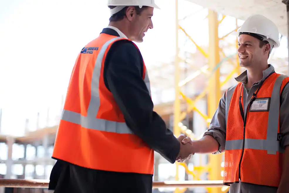 Construction professionals discussing dust control solutions on site