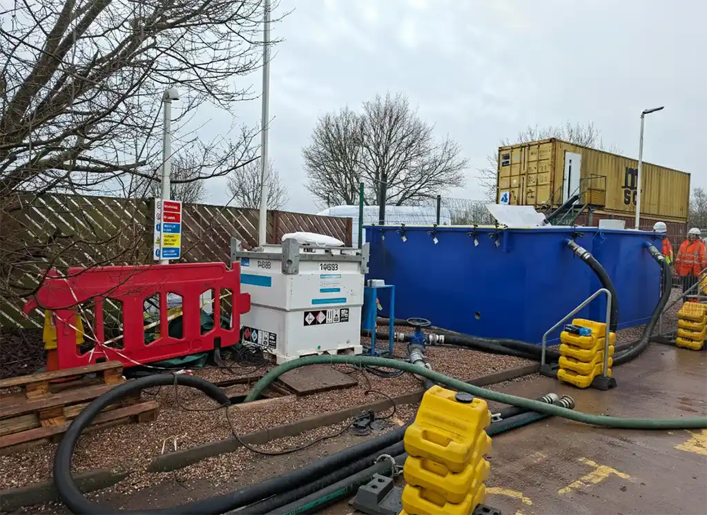 Rapidly deployed temporary water treatment equipment installed on a live petrol station forecourt to manage contaminated groundwater following an underground fuel tank leak.