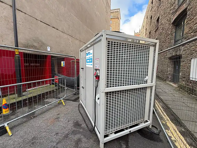 HPAC45 air conditioning unit positioned externally with ducting routed into theatre building for server room cooling