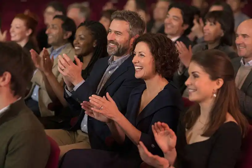 Audience applauding during live theatre production in temperature-controlled environment