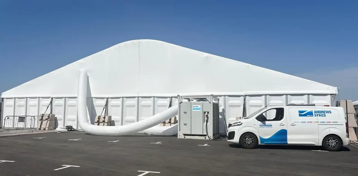 HPAC90 air conditioning unit installed outside motorsport event marquee HPAC90 high performance air conditioner and Andrews Sykes van positioned outside a large white event marquee with overhead ducting