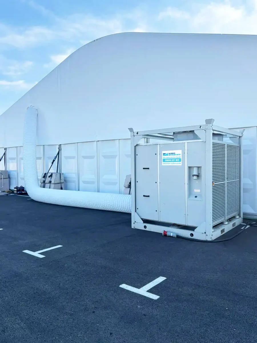 HPAC90 high performance air conditioner with white perforated ducting HPAC90 high performance air conditioner with white perforated ducting running into a motorsport event marquee