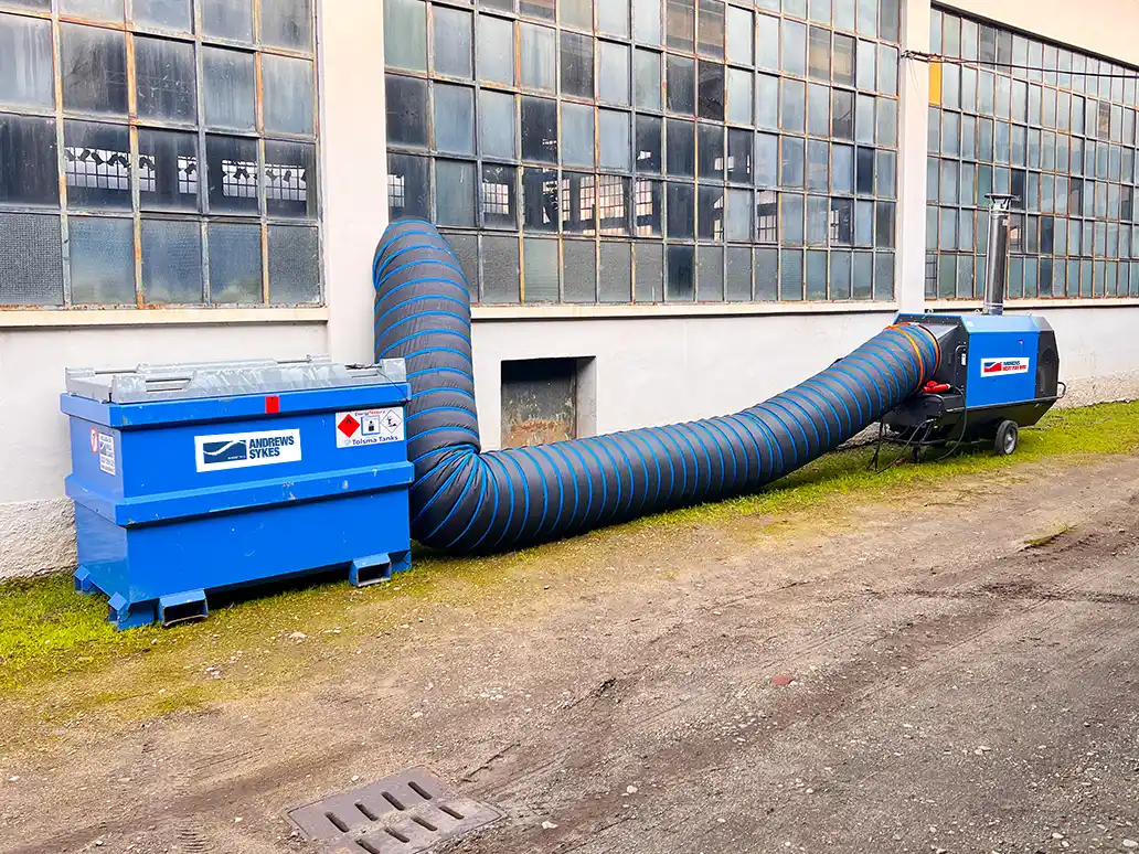 IHO Fuel Tank and Heater Setup Portable fuel tank connected to temporary heating equipment for efficient site heating.