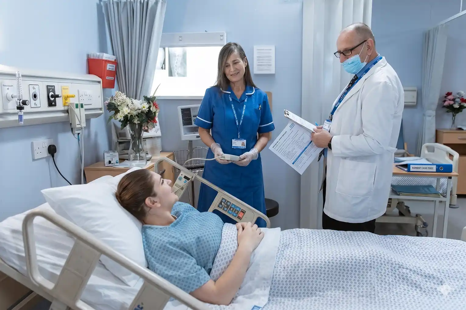Healthcare staff with patient in hospital room with temporary cooling and HEPA filtration