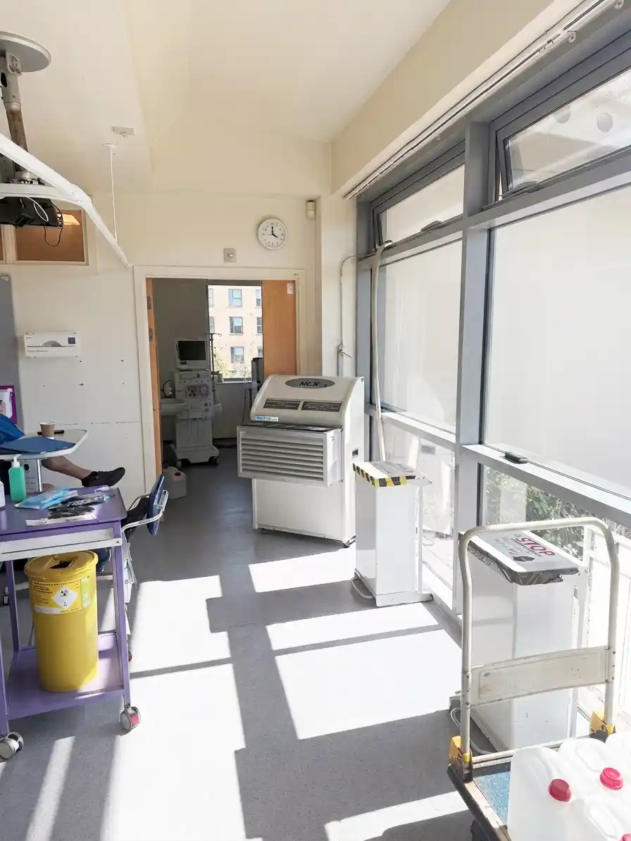 https://www.andrews-sykes.com/wp-content/uploads/2026/08/PAC22-Cooling-Unit-in-Healthcare-Setting.webp PAC22 portable air conditioner installed in hospital renal unit to provide cooling and HEPA filtration
