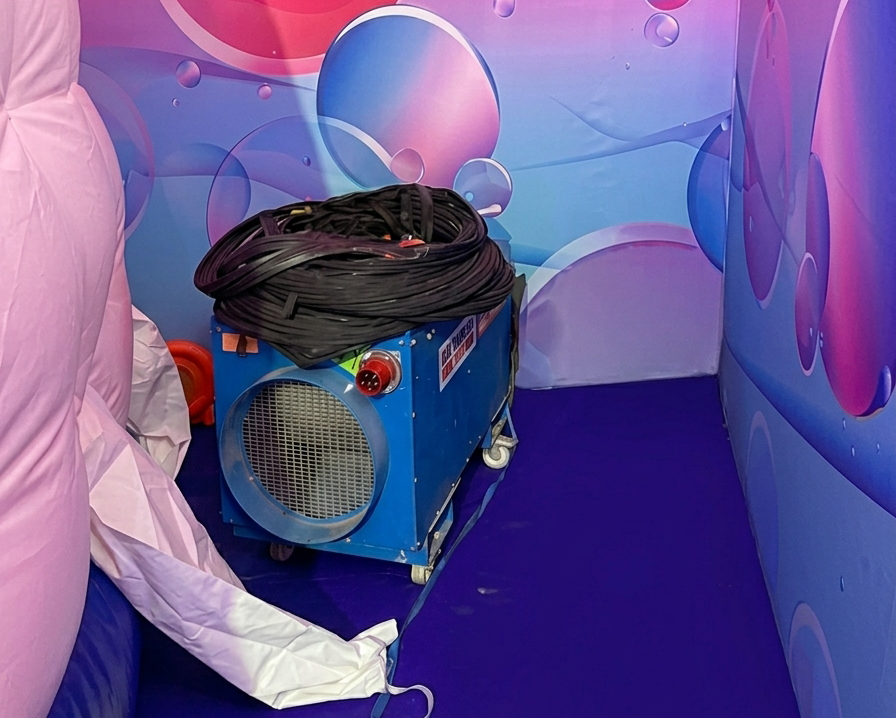DE190 42kW electric heater positioned in a side bay of the children's event set, supplying fume-free warm air
